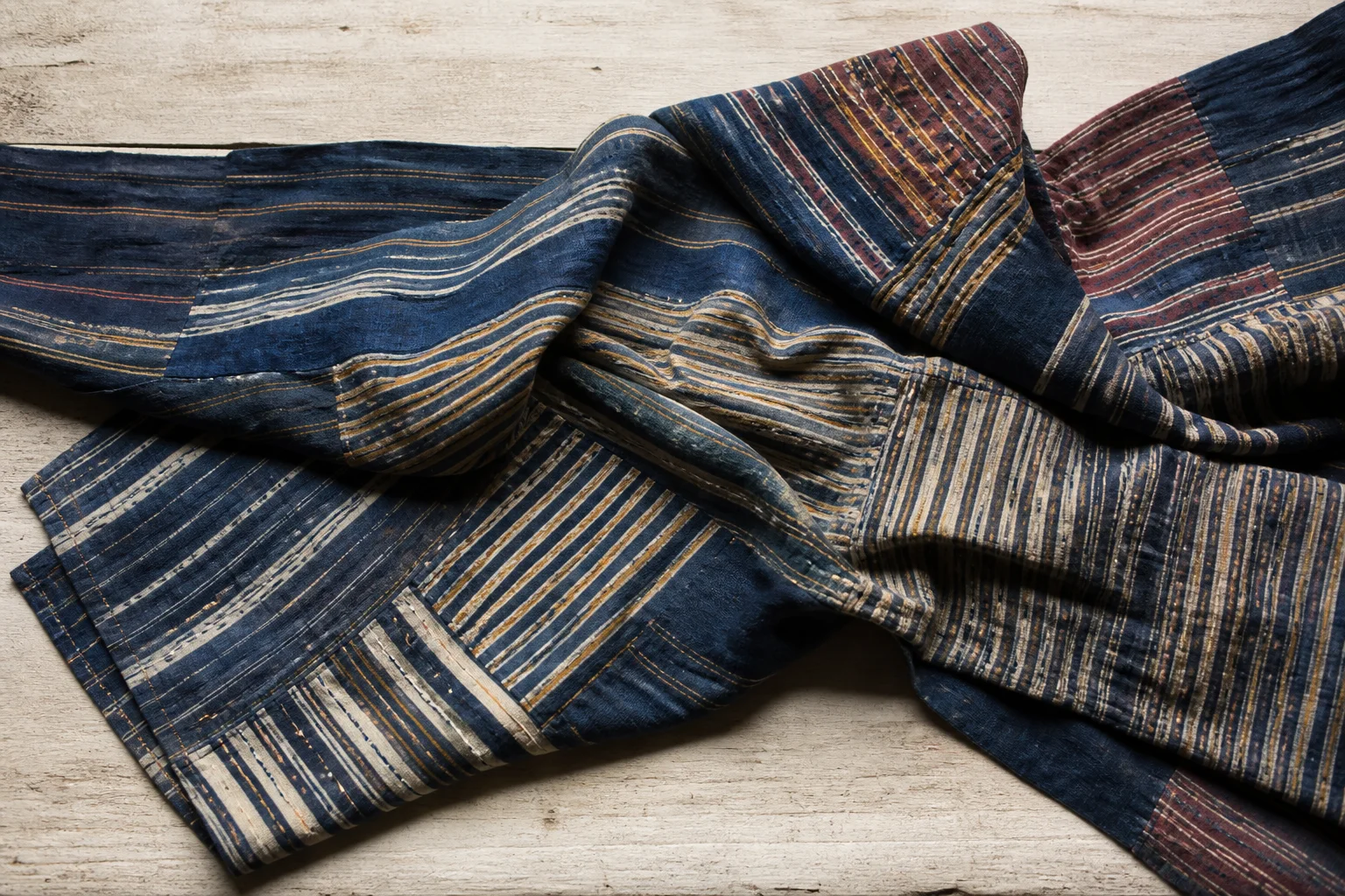 Folded textile with diagonal and horizontal striped resist rhythms